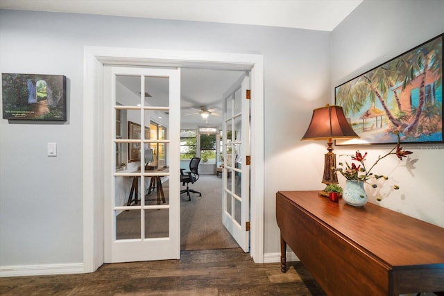 doorway with a ceiling fan, baseboards, wood finished floors, and french doors