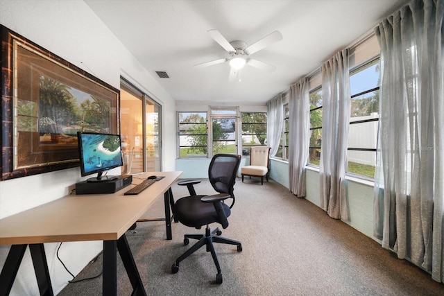 carpeted home office featuring a healthy amount of sunlight, visible vents, and a ceiling fan