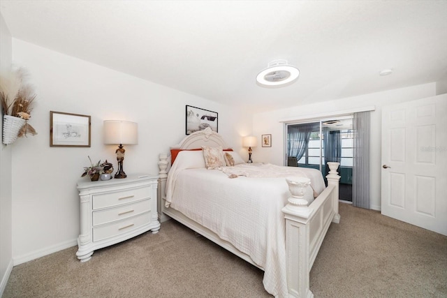 bedroom featuring baseboards and light colored carpet