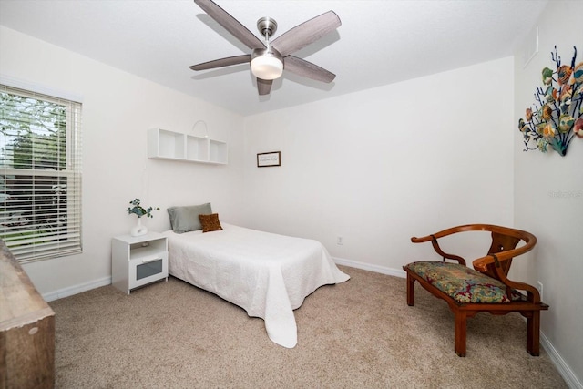 carpeted bedroom featuring a ceiling fan and baseboards