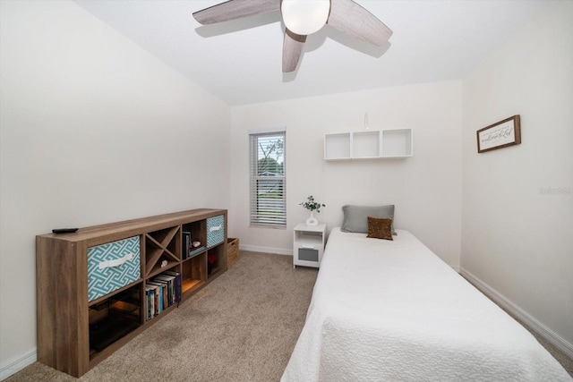 carpeted bedroom featuring baseboards and a ceiling fan