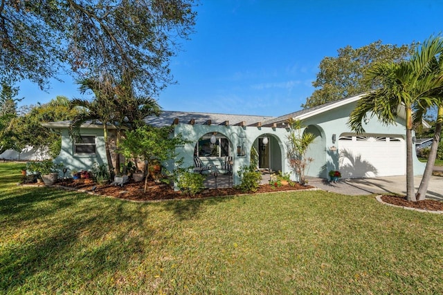 view of front of home with a garage, a front yard, driveway, and stucco siding