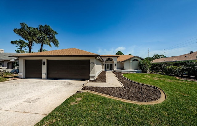 ranch-style house featuring stucco siding, an attached garage, driveway, and a front lawn