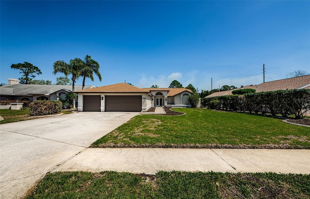 ranch-style home featuring a front yard, a garage, driveway, and stucco siding