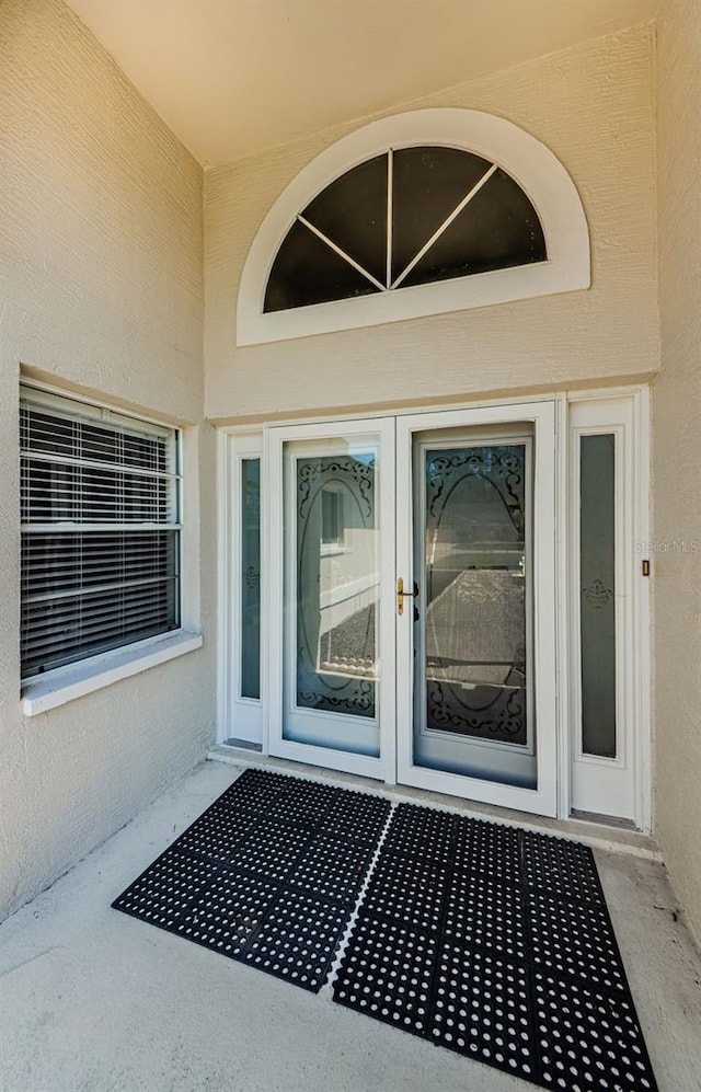 entrance to property featuring stucco siding