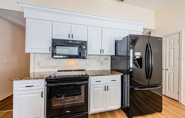 kitchen featuring black appliances, dark stone countertops, and tasteful backsplash