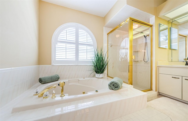 bathroom featuring a jetted tub, a stall shower, and vanity