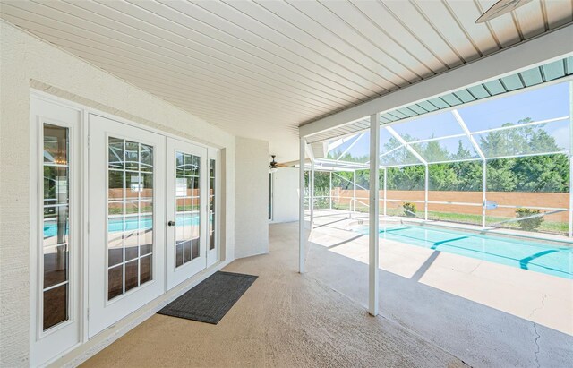 view of swimming pool with a patio, fence, glass enclosure, french doors, and a fenced in pool