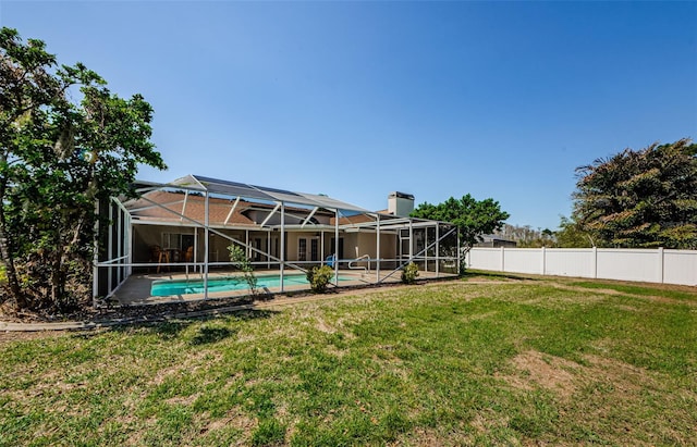 view of yard featuring a lanai, an outdoor pool, and fence