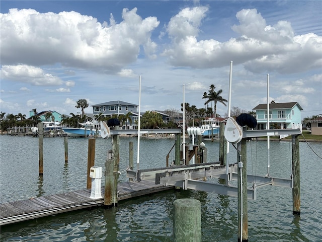 dock area with a water view and boat lift