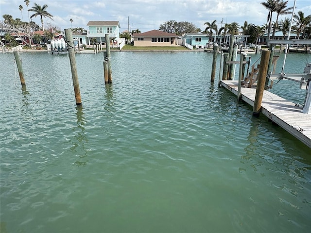 dock area with a residential view, a water view, and boat lift