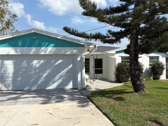 ranch-style house with an attached garage and a front yard