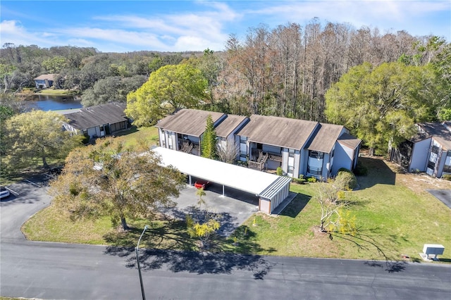 birds eye view of property with a view of trees