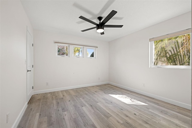 spare room featuring light wood-style flooring and baseboards