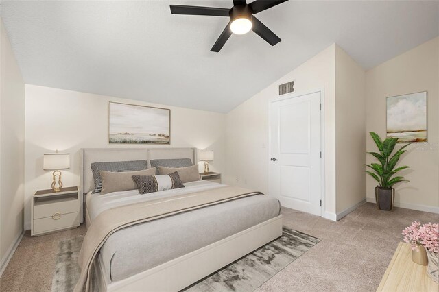 bedroom featuring visible vents, baseboards, vaulted ceiling, carpet flooring, and a ceiling fan