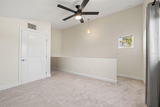 unfurnished room with light carpet, visible vents, ceiling fan, and baseboards