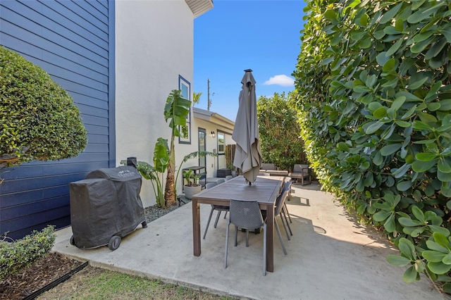 view of patio / terrace featuring area for grilling and outdoor dining area