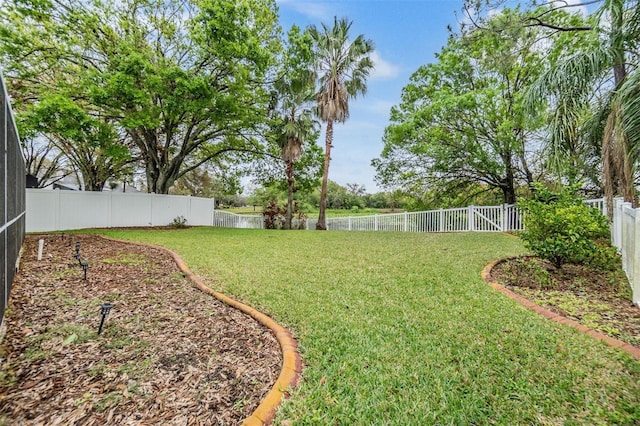 view of yard featuring a lanai and a fenced backyard