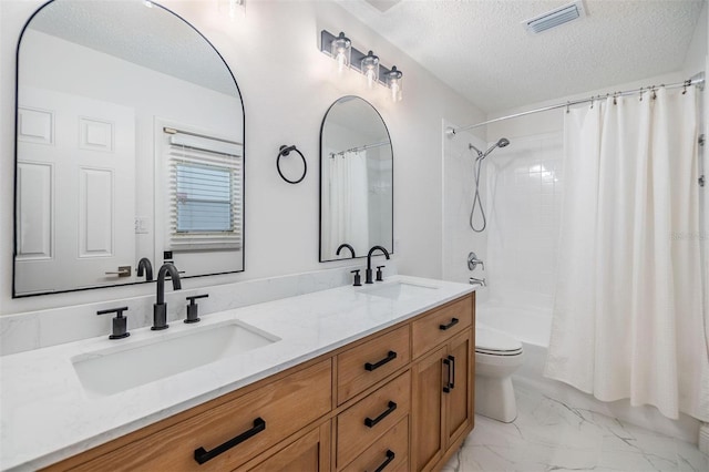 full bathroom with a textured ceiling, marble finish floor, a sink, and visible vents