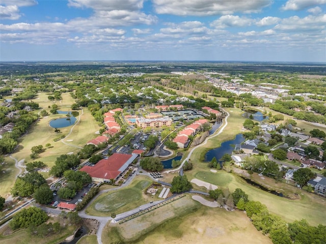 drone / aerial view with a water view and golf course view