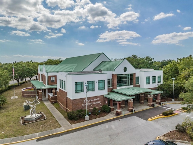 view of building exterior with aphalt driveway