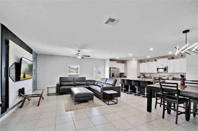 1773 Yellow Trl, Lakeland, FL 33801 - living room with ceiling fan with notable chandelier, light tile patterned flooring, visible vents, and recessed lighting