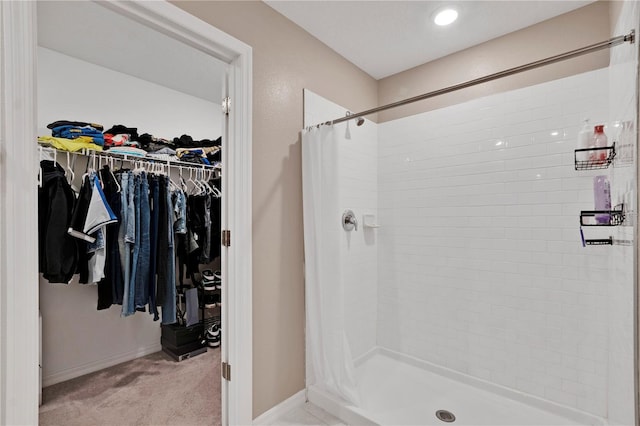 1773 Yellow Trl, Lakeland, FL 33801 - bathroom featuring a stall shower, a spacious closet, and baseboards