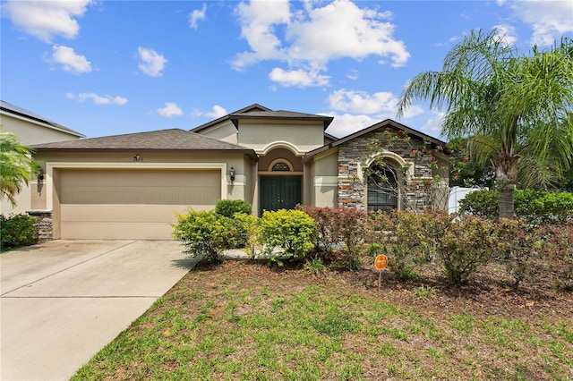 view of front of property with a garage, driveway, stone siding, and stucco siding