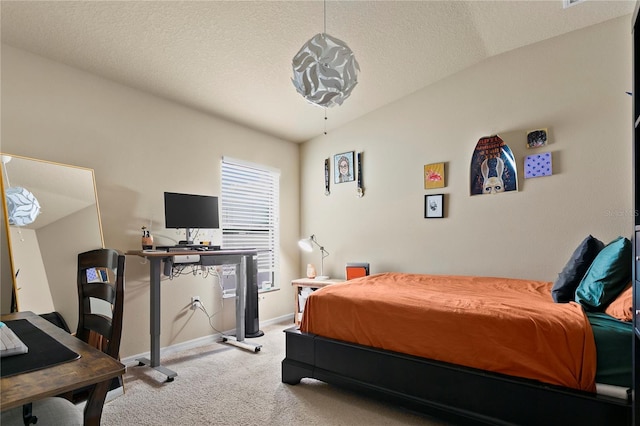 carpeted bedroom with a textured ceiling and baseboards