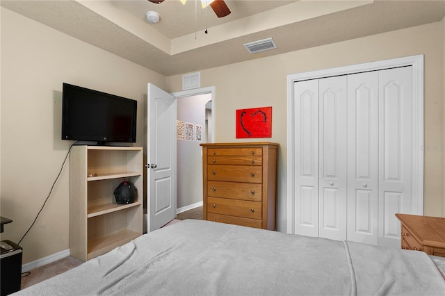 bedroom with baseboards, visible vents, and a closet