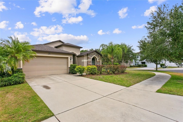 view of front of home with stucco siding, a garage, stone siding, driveway, and a front lawn