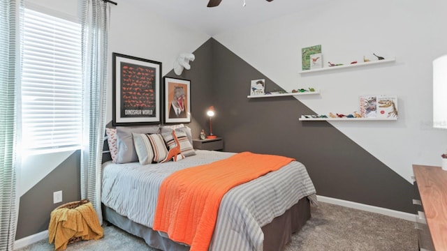 carpeted bedroom featuring a ceiling fan, lofted ceiling, and baseboards