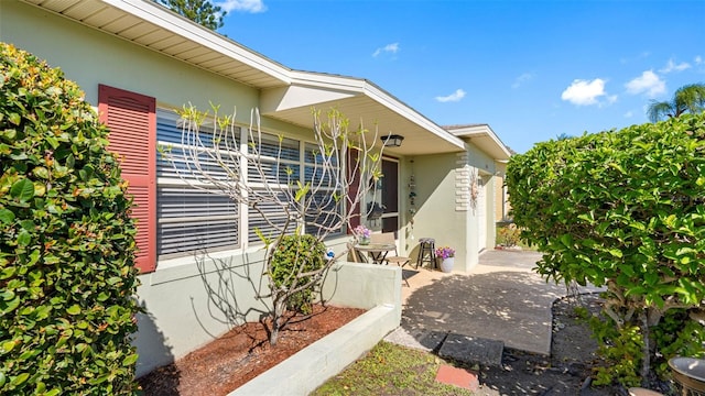 view of side of property with a patio and stucco siding