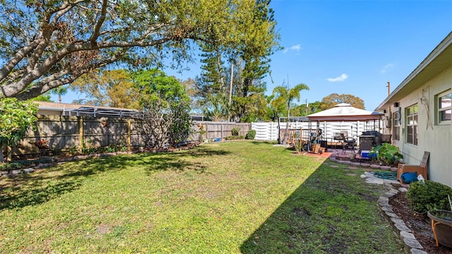 view of yard with a fenced backyard, a patio, and a gazebo