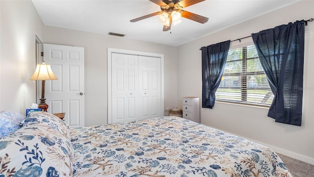 carpeted bedroom with a ceiling fan, baseboards, visible vents, and a closet