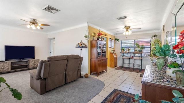 living room with light tile patterned floors, visible vents, and a ceiling fan