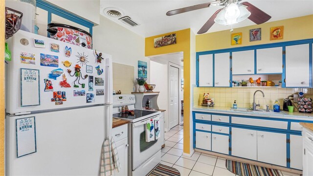 kitchen with white appliances, tasteful backsplash, light tile patterned floors, light countertops, and open shelves