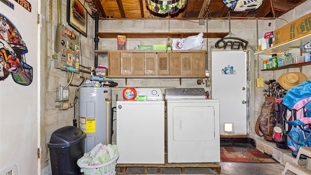 washroom featuring water heater, laundry area, and washing machine and dryer