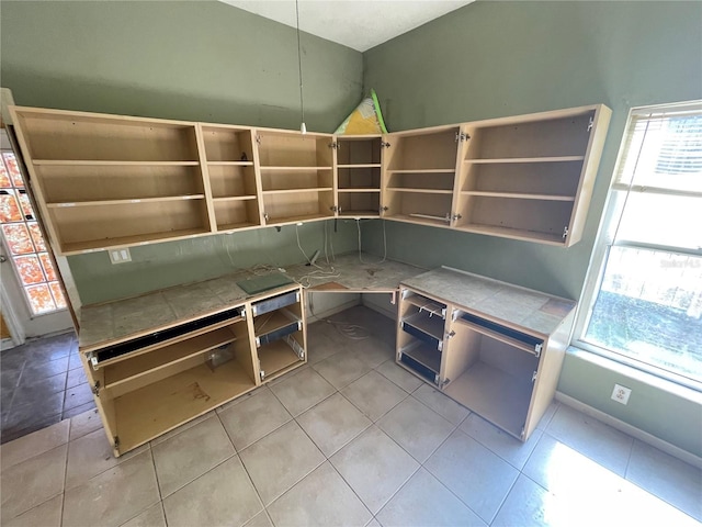 kitchen with light tile patterned floors and open shelves