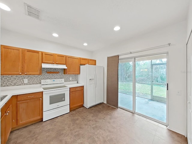 kitchen featuring under cabinet range hood, white appliances, visible vents, light countertops, and tasteful backsplash