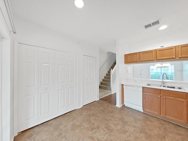 kitchen featuring a sink, visible vents, light countertops, brown cabinets, and dishwasher