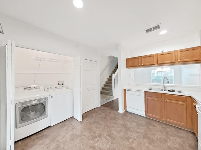 kitchen featuring light countertops, visible vents, white dishwasher, a sink, and independent washer and dryer