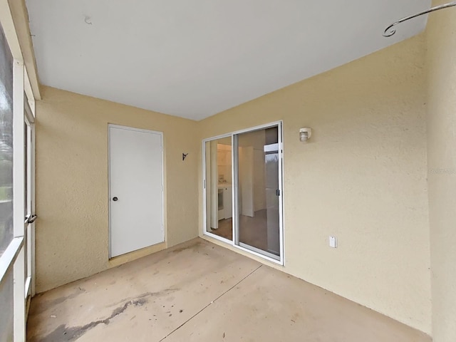 unfurnished sunroom with washer / dryer