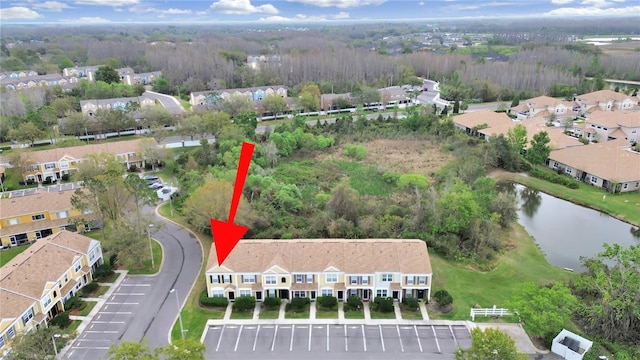 drone / aerial view featuring a residential view and a water view