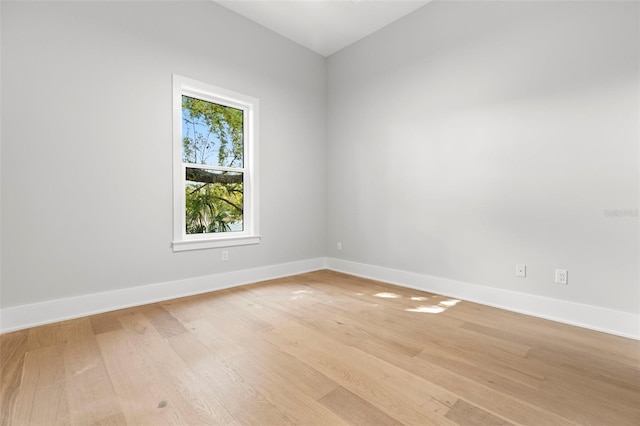 empty room featuring baseboards and light wood-style floors