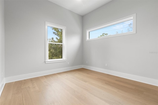 spare room with light wood finished floors and baseboards