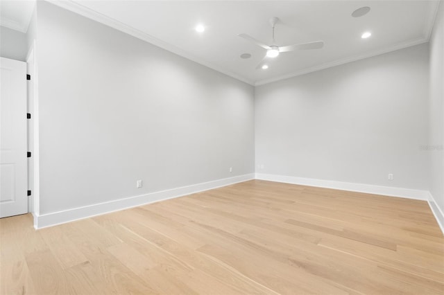 empty room with light wood-type flooring, baseboards, and crown molding