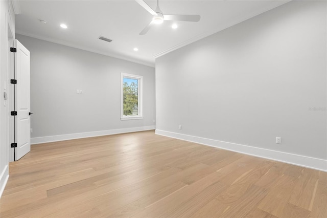 empty room with baseboards, visible vents, and light wood-style floors