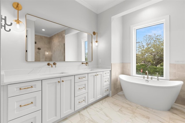 bathroom with a soaking tub, marble finish floor, a sink, and double vanity