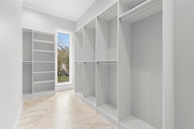 walk in closet featuring marble finish floor